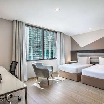 a room with two beds and a desk