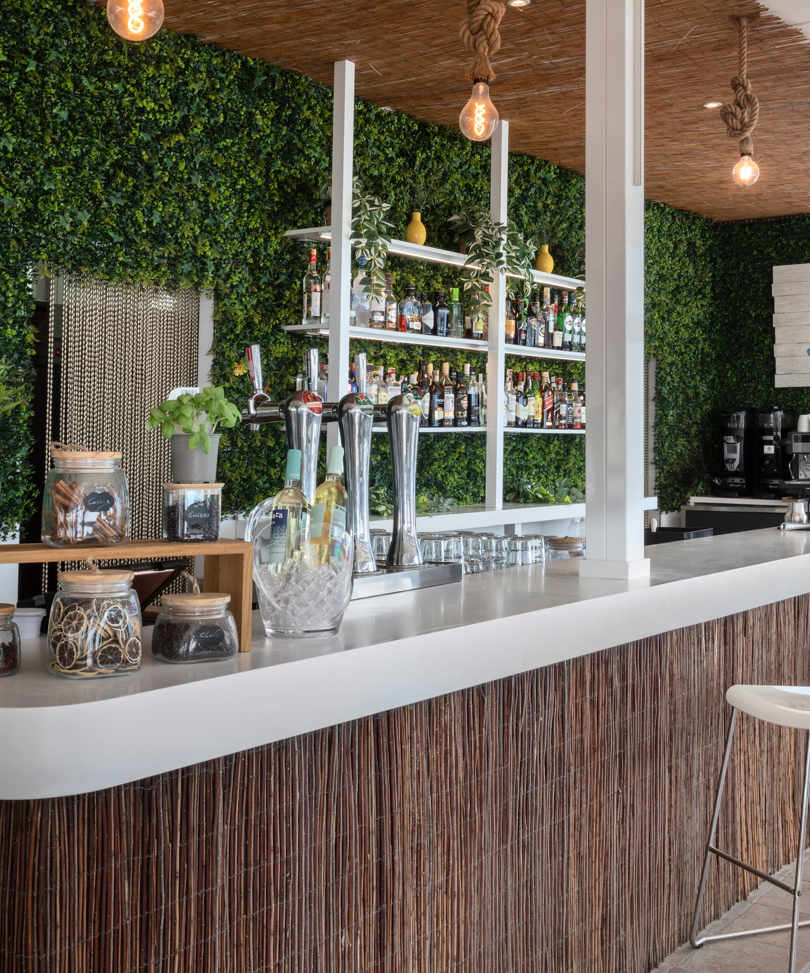 a bar with a white counter and a white chair
