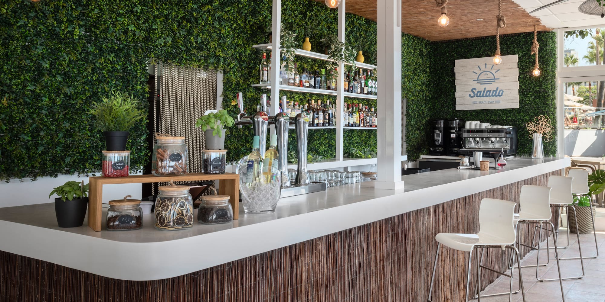 a bar with a white counter and a white chair
