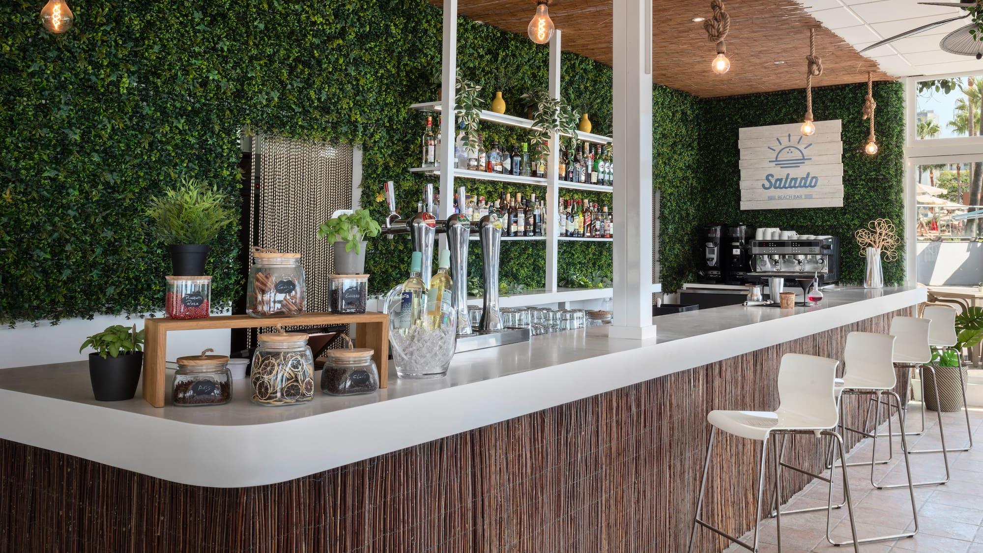 a bar with a white counter and a white chair