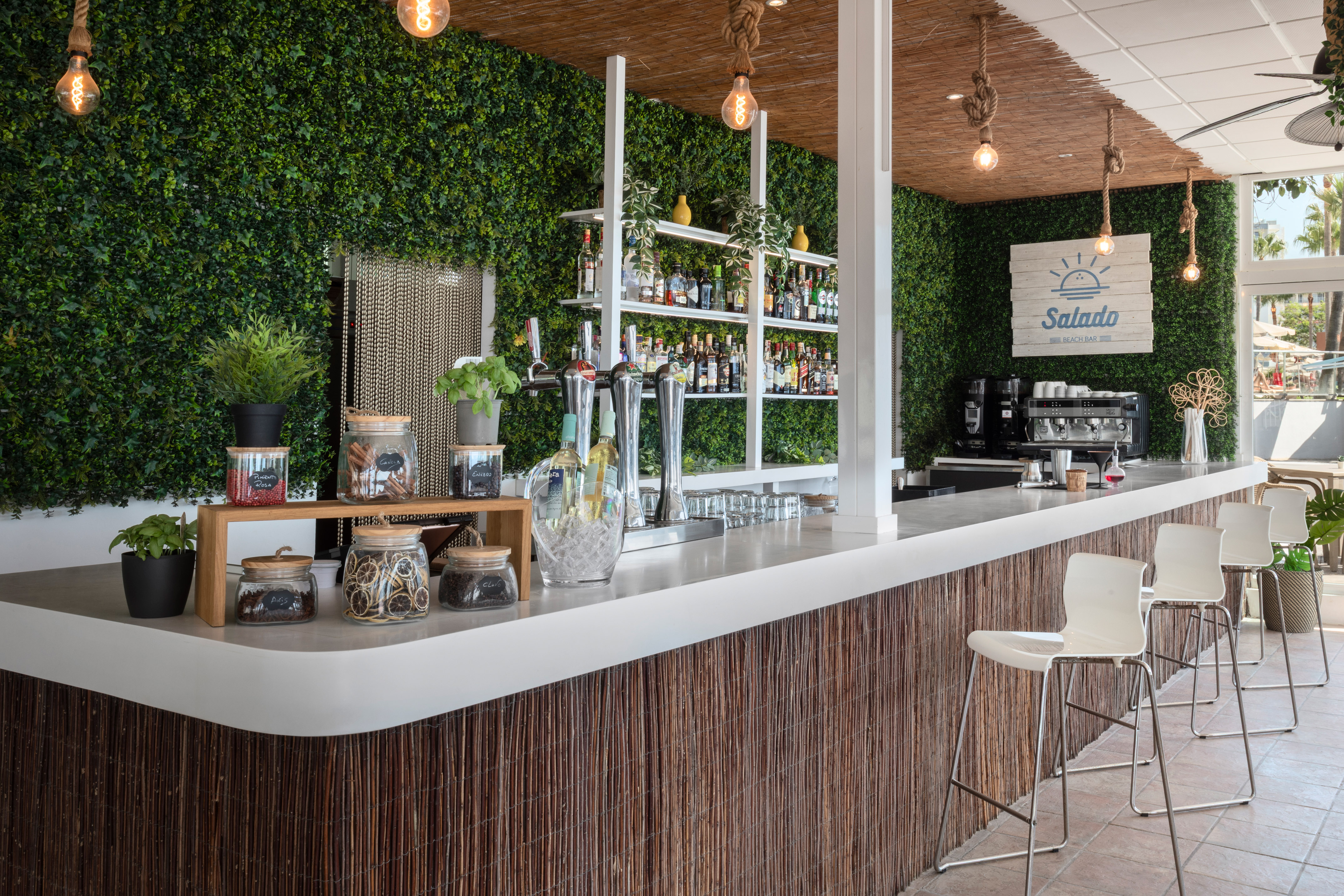 a bar with a white counter and a white chair