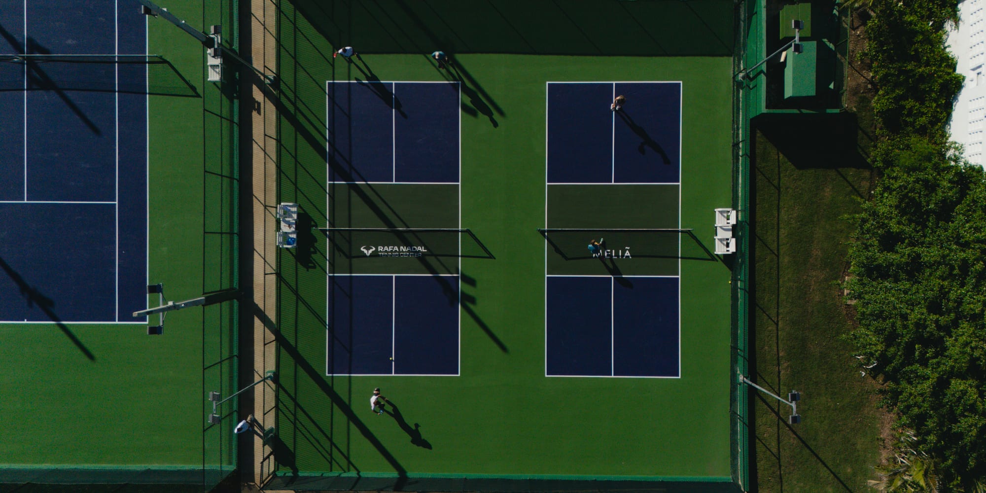a tennis court with people playing tennis
