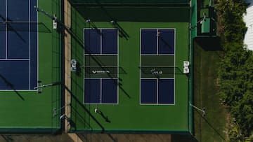 a tennis court with people playing tennis