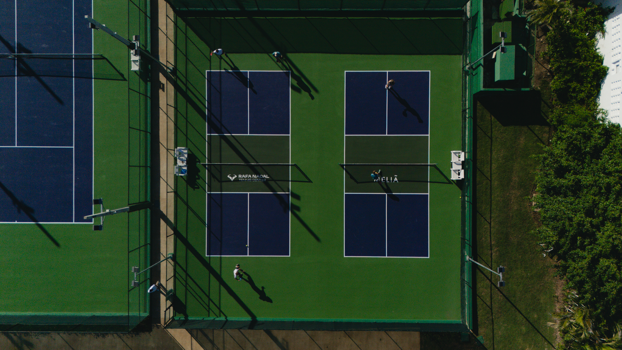 Rafa Nadal Tennis Center padel courts from above, players, Meliá resort.