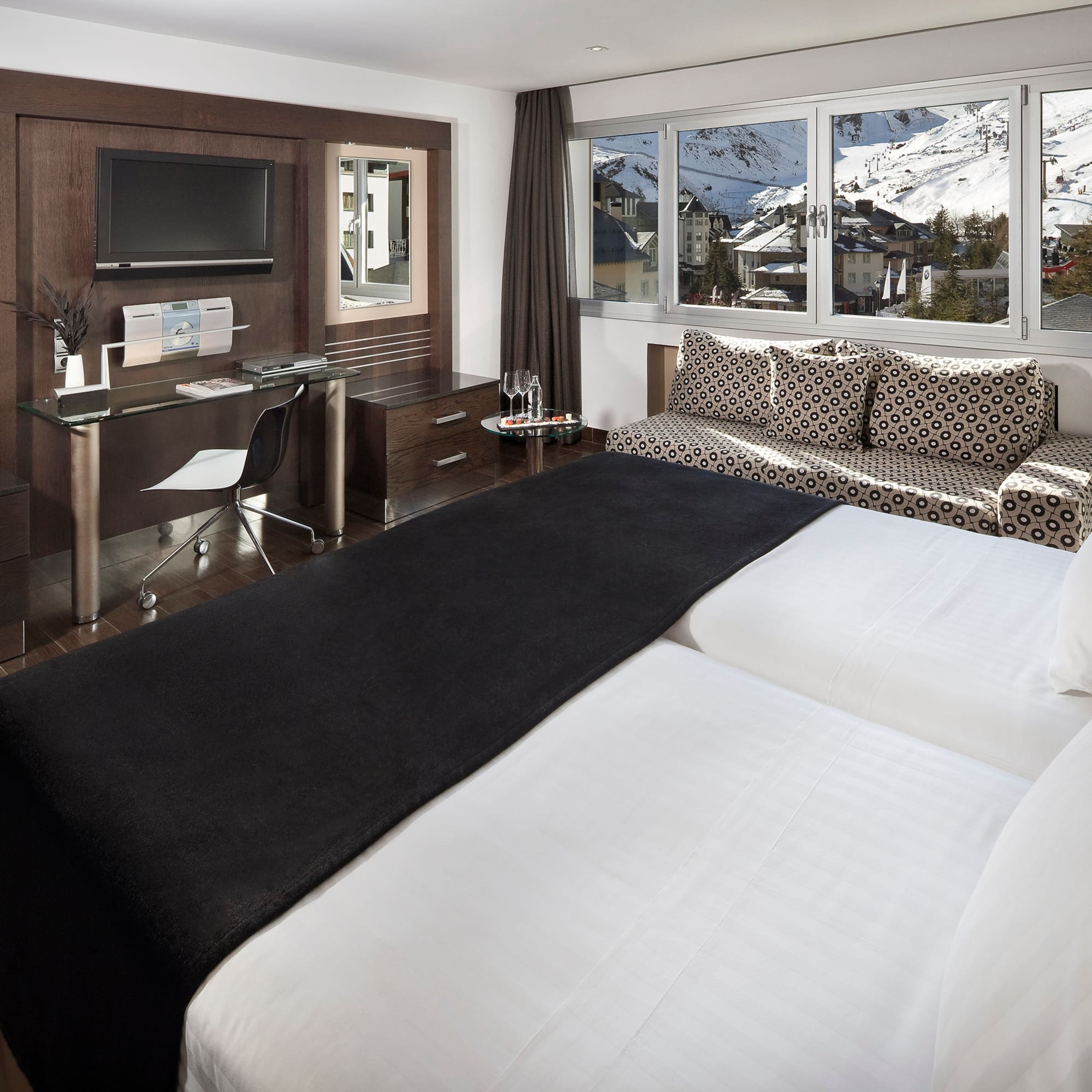 a room with two beds and a desk