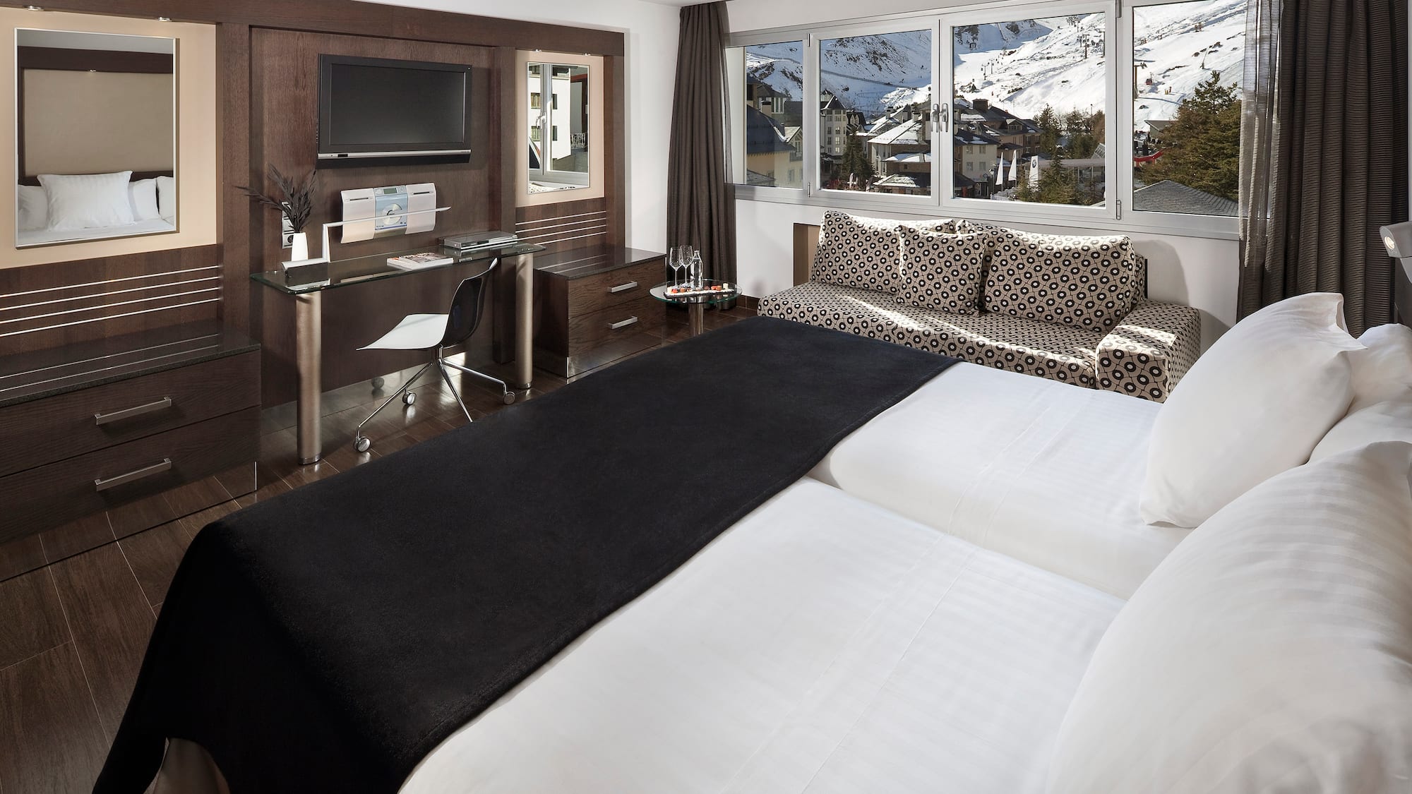 a room with two beds and a desk