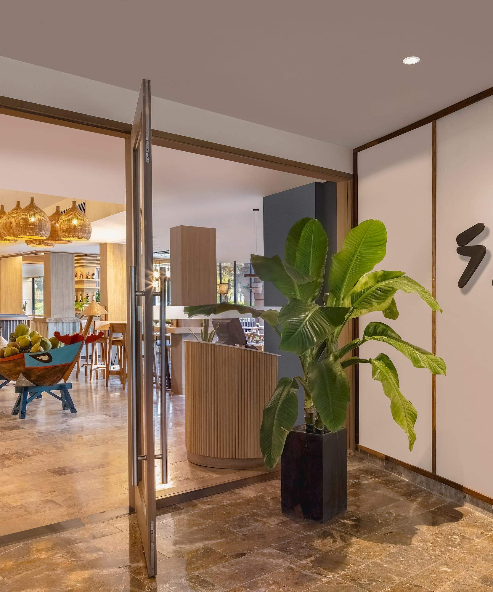 a glass door with a plant in it