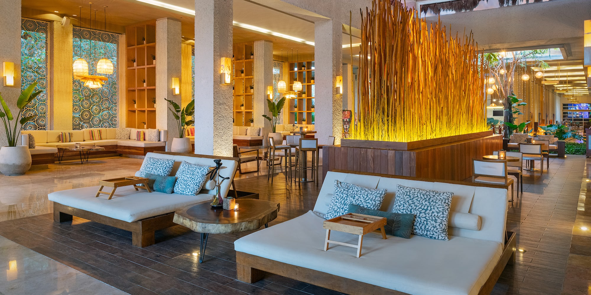 a room with a large white couches and tables