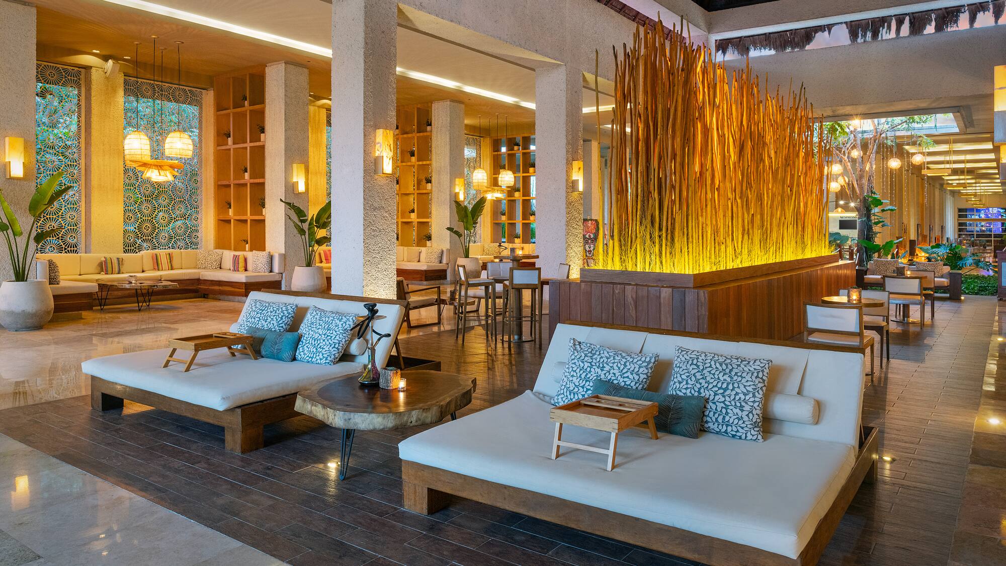 a room with a large white couches and tables