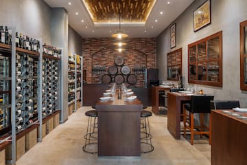 a room with a bar and wine bottles