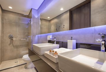 a bathroom with a glass shower and two sinks