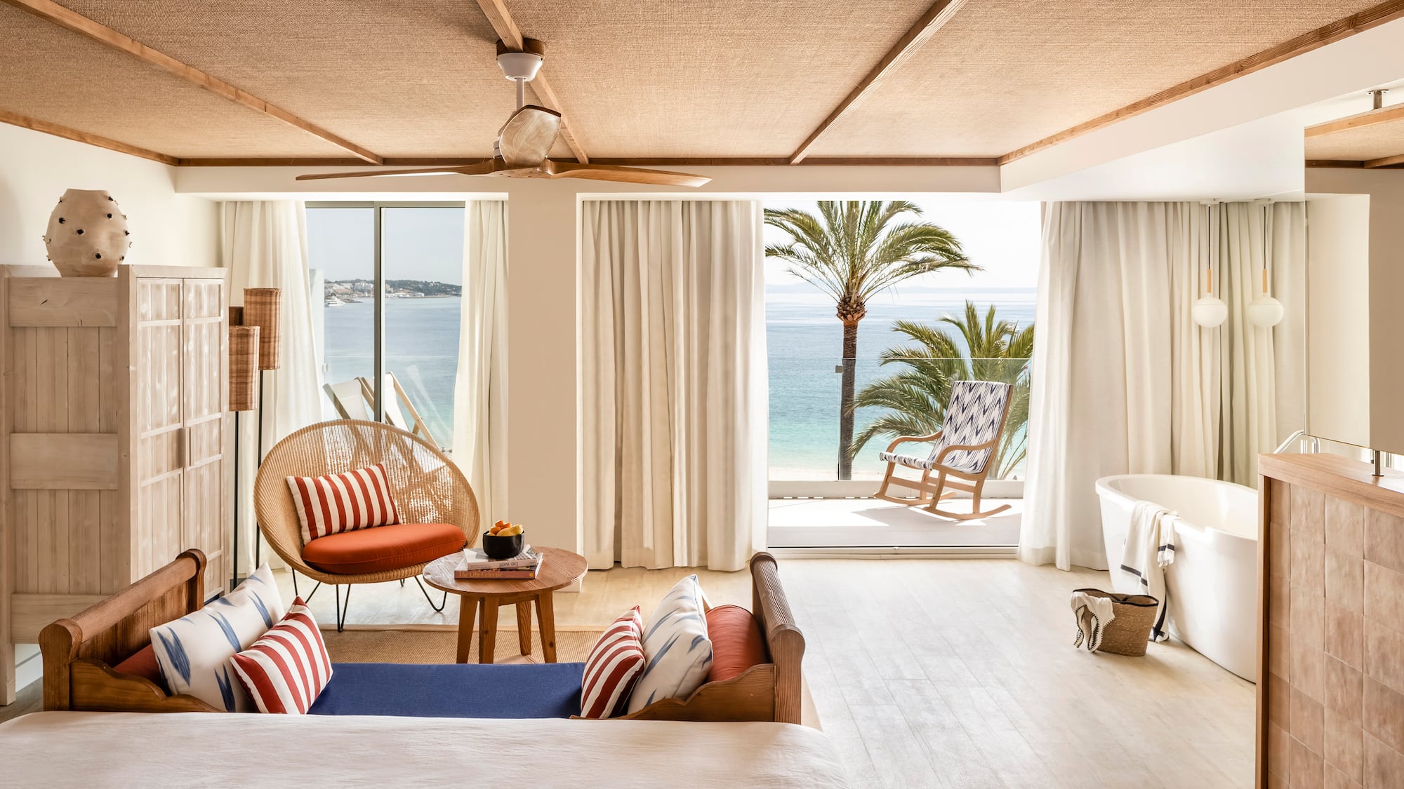 a room with a view of the ocean and a beach