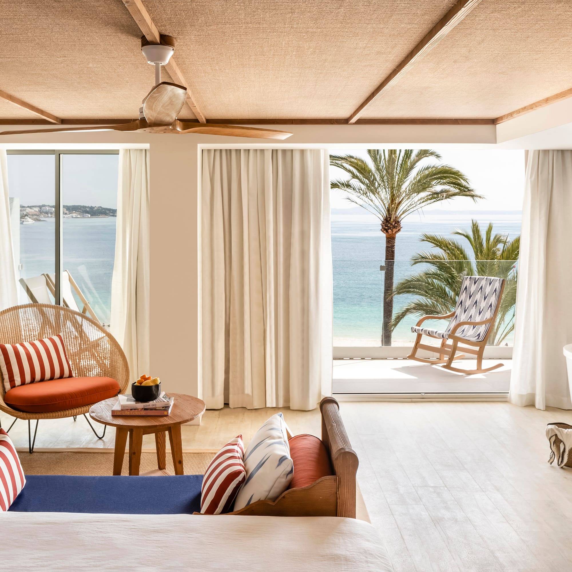 a room with a view of the ocean and a beach