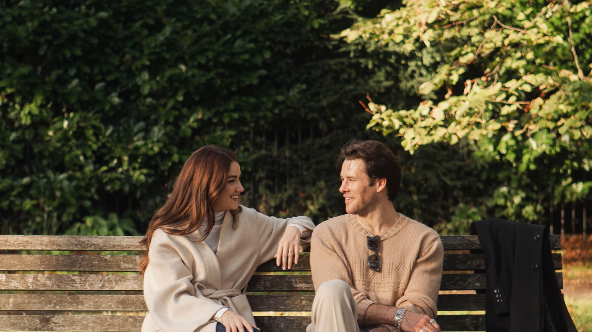 a man and woman sitting on a bench