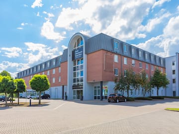a building with trees and cars in front of it