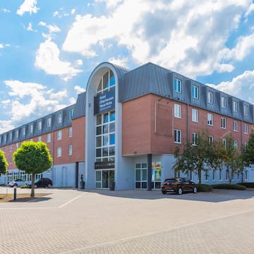 a building with trees and cars in front of it