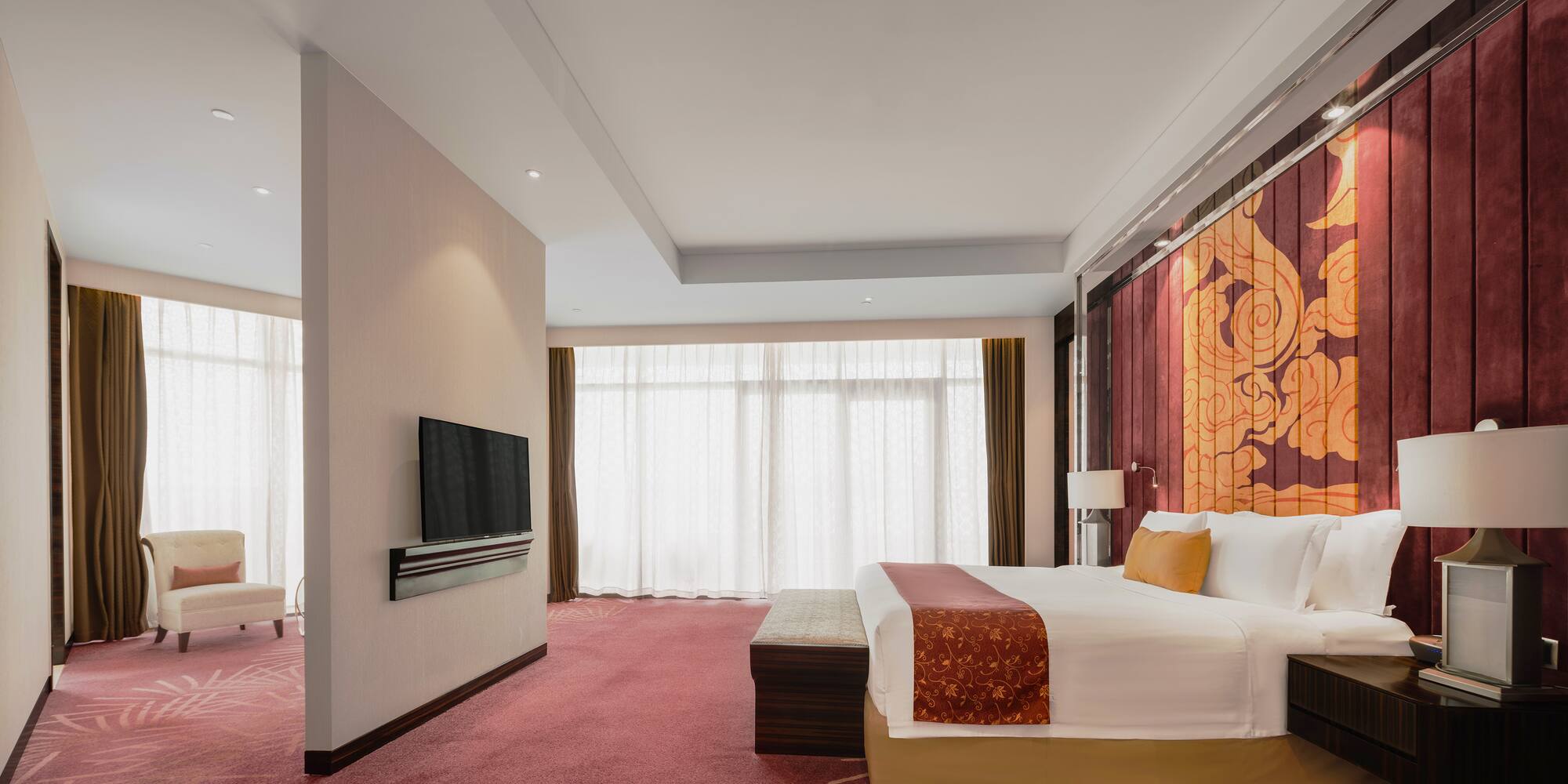 a room with a bed and a television