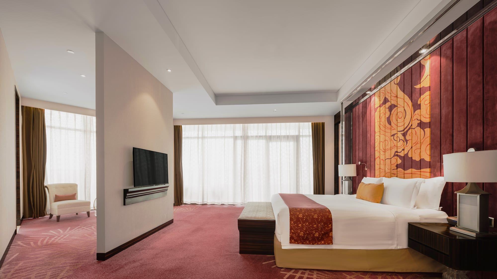 a room with a bed and a television