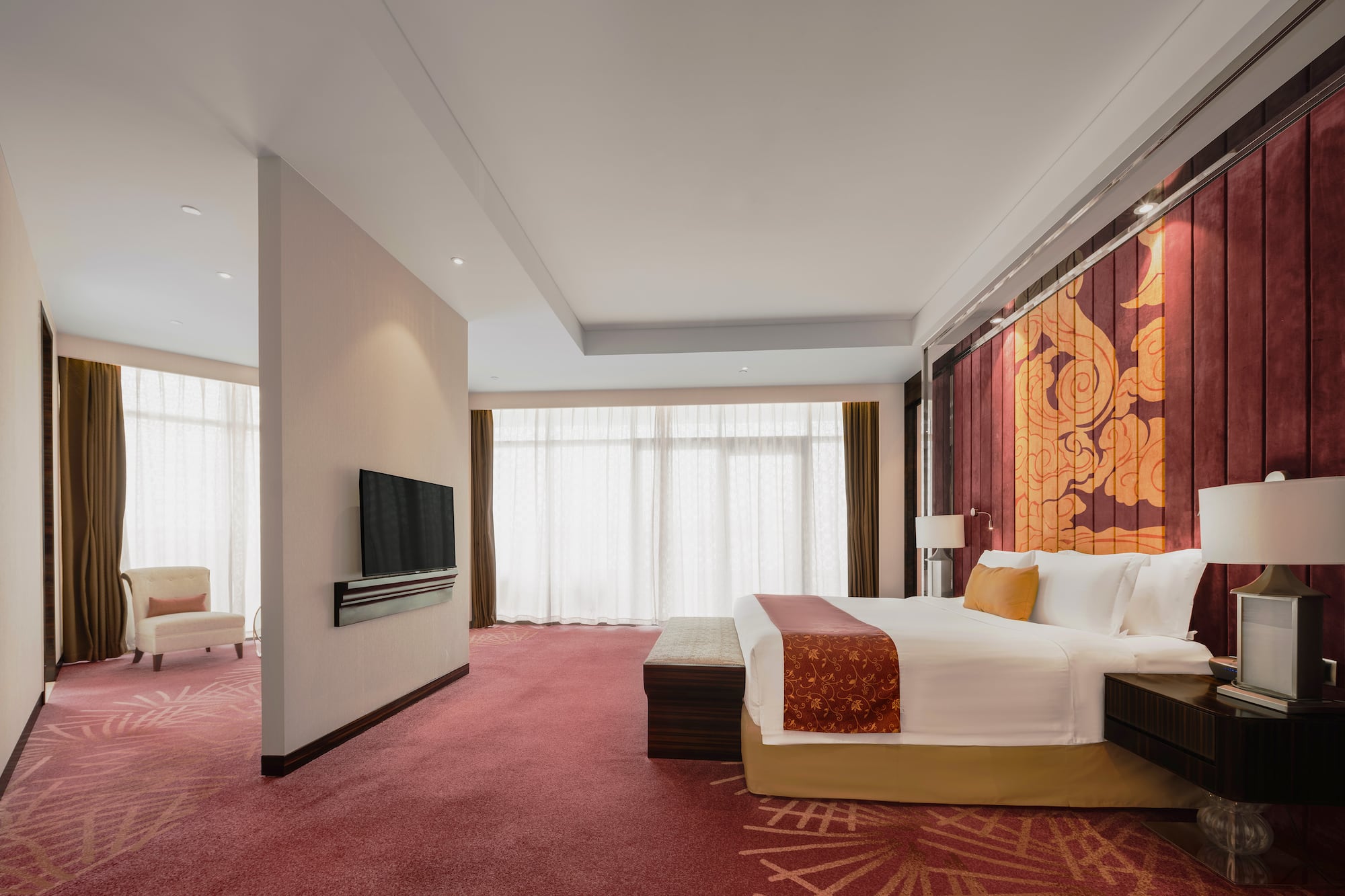 a room with a bed and a television