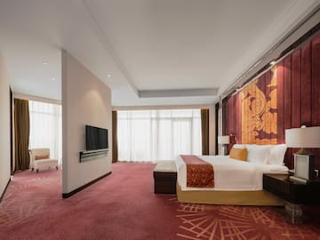 a room with a bed and a television