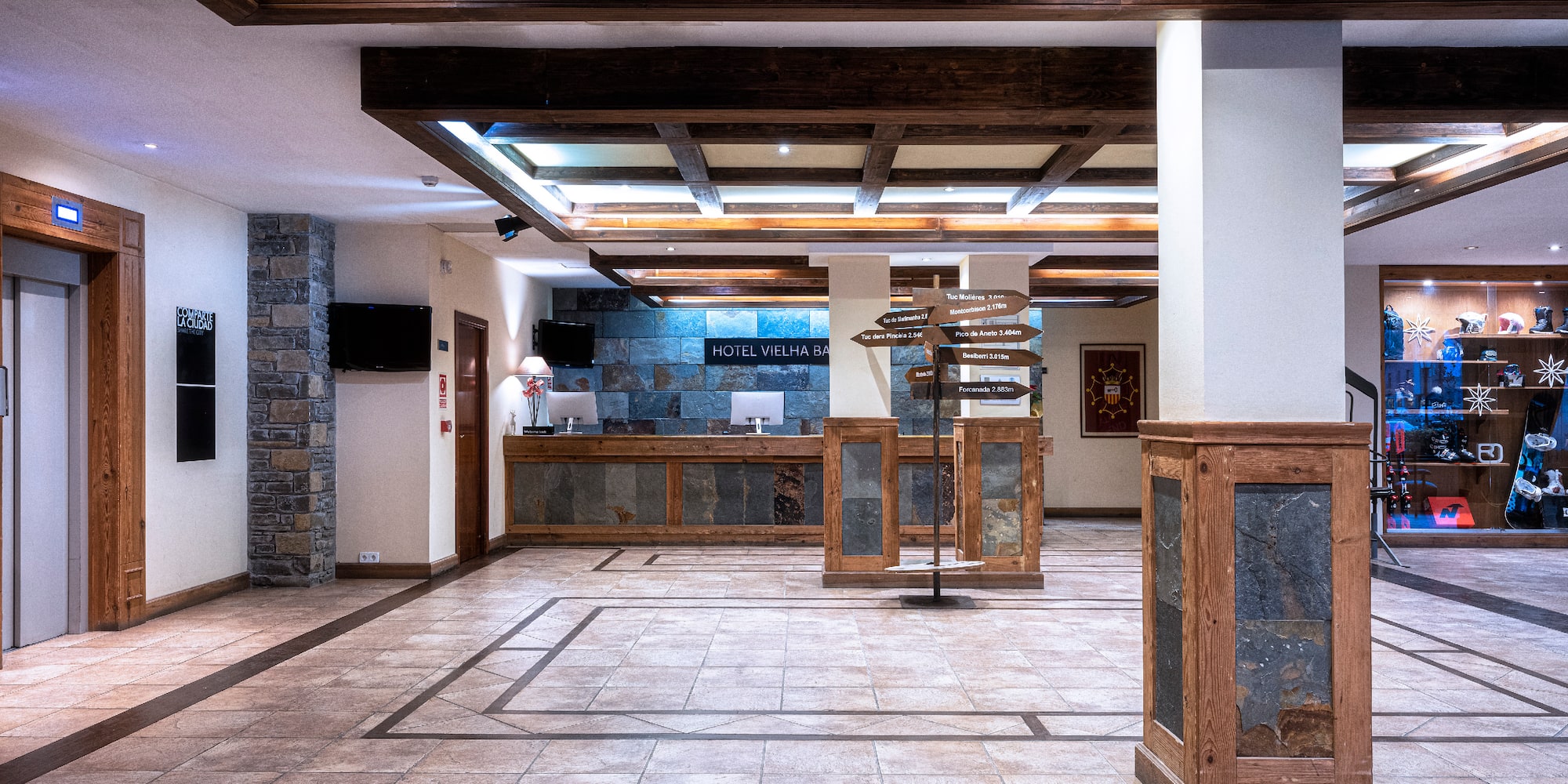 a large room with a stone floor and a stone wall