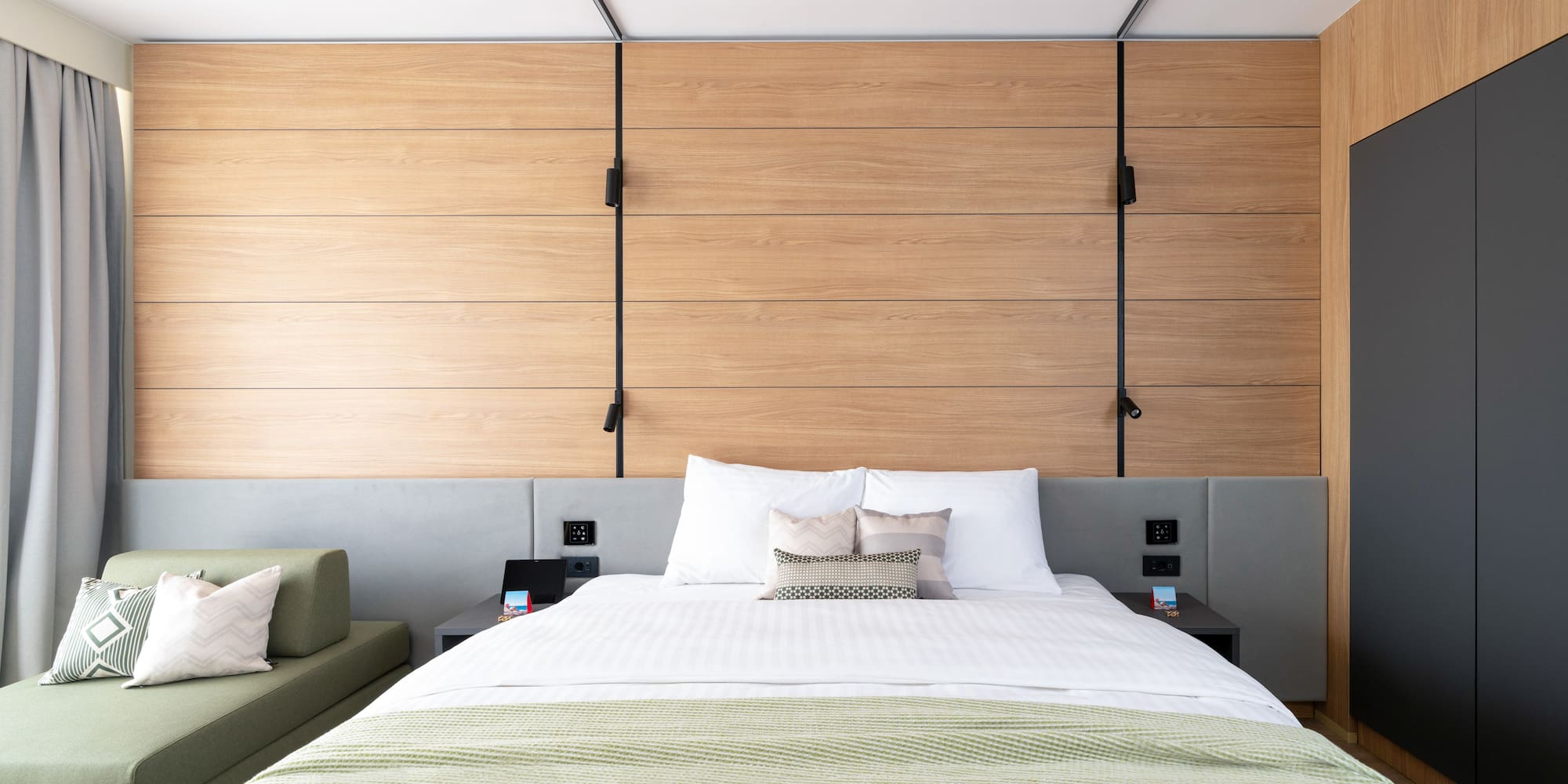 a bed with pillows and a couch in a room