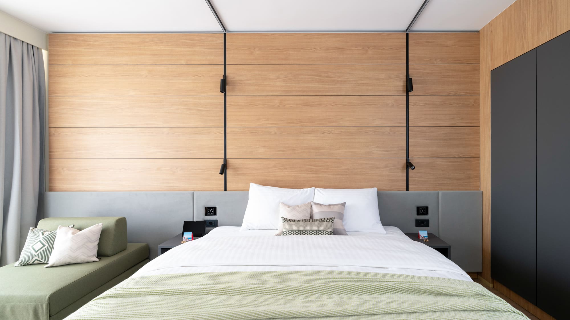 a bed with pillows and a couch in a room