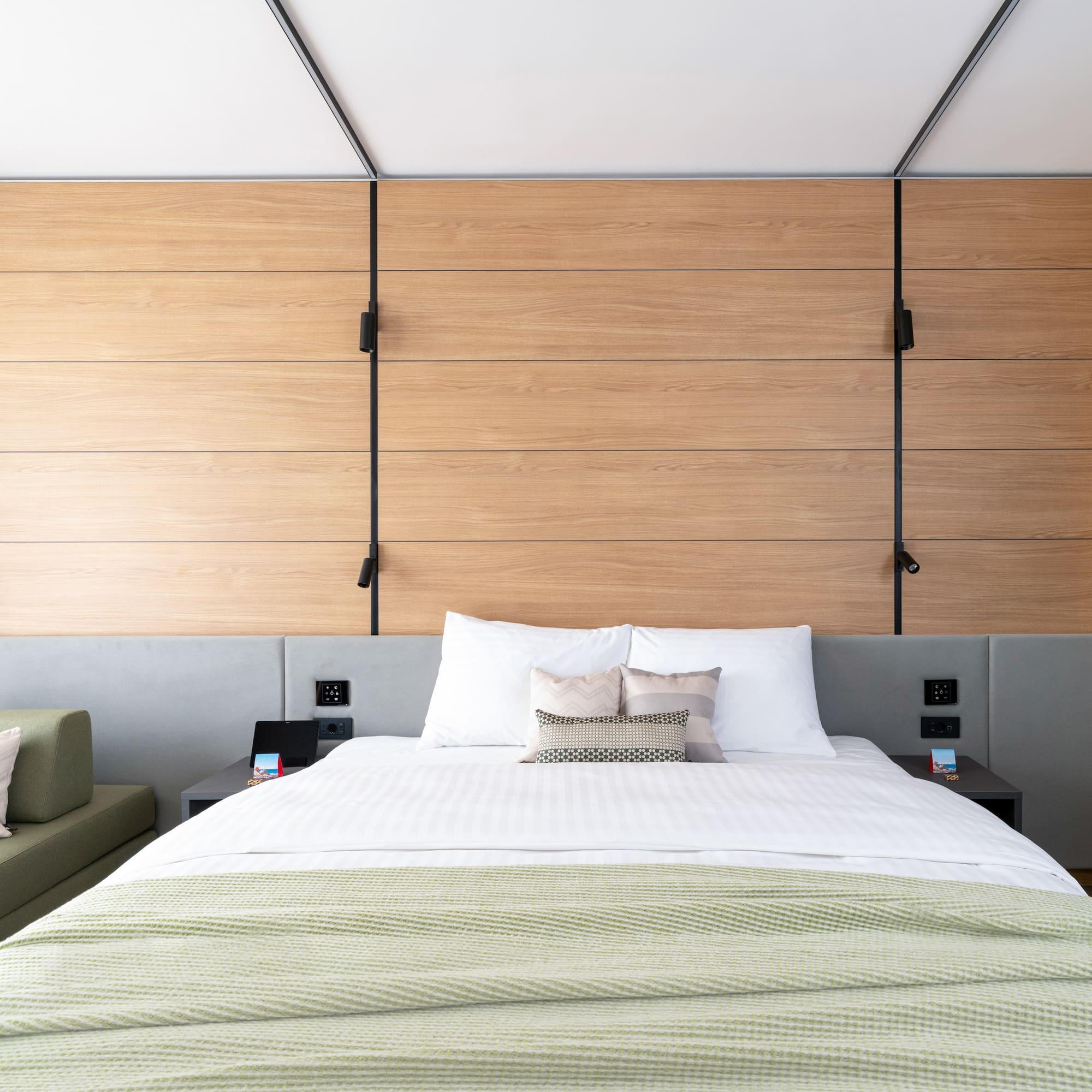 a bed with pillows and a couch in a room