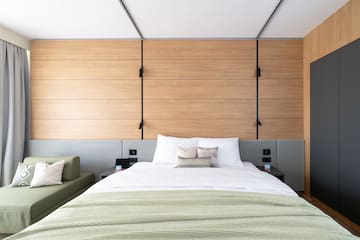 a bed with pillows and a couch in a room