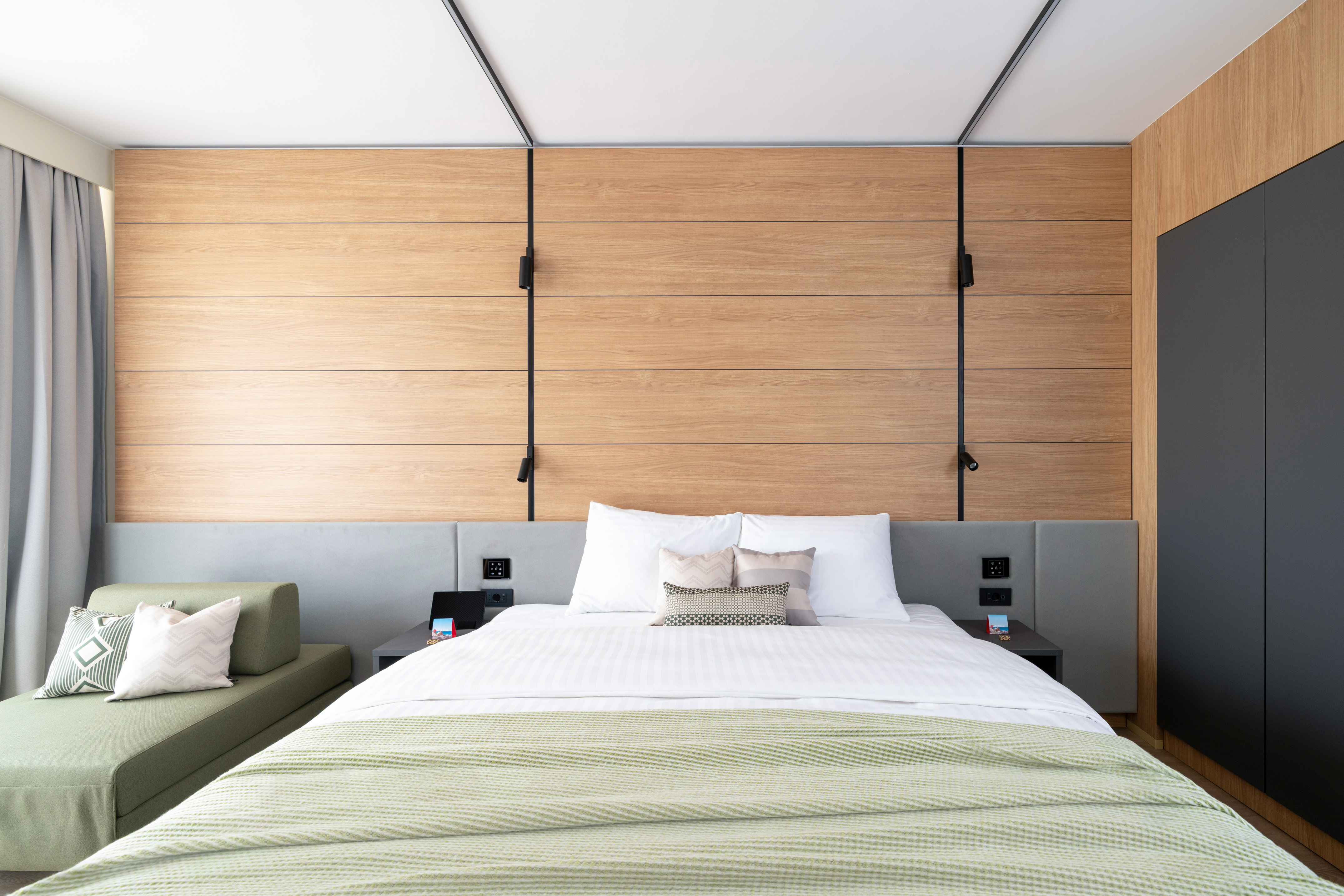 a bed with pillows and a couch in a room