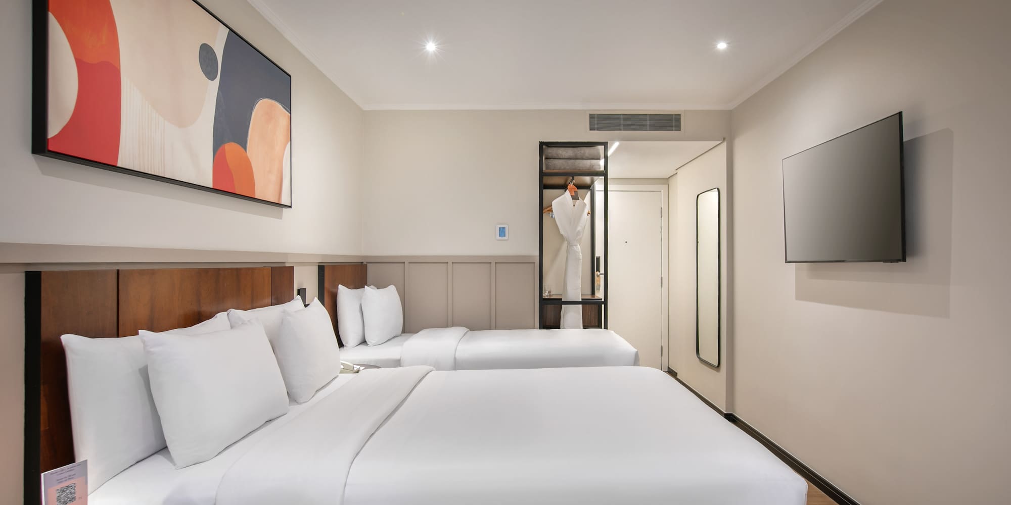 a room with two beds and a tv
