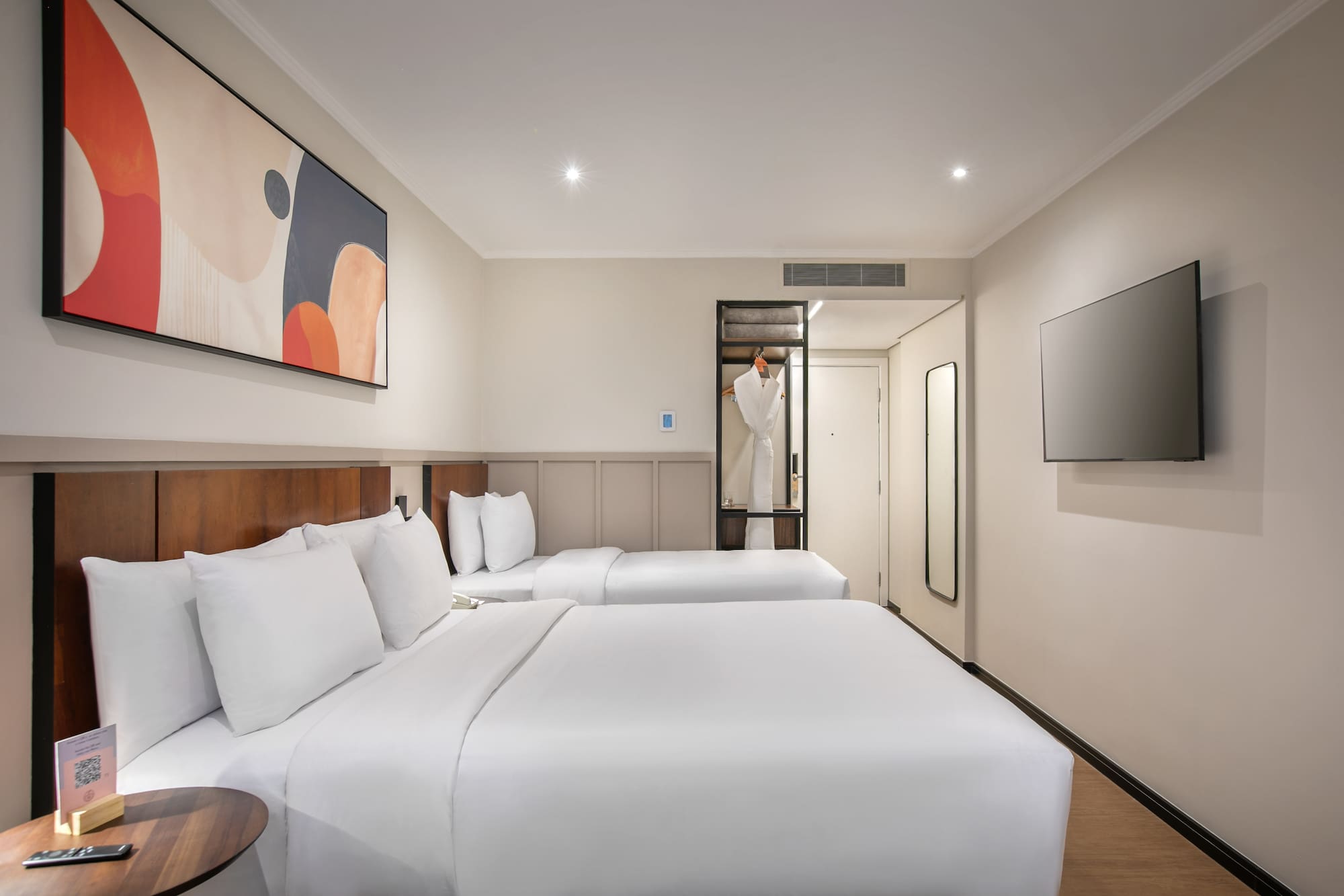 a room with two beds and a tv