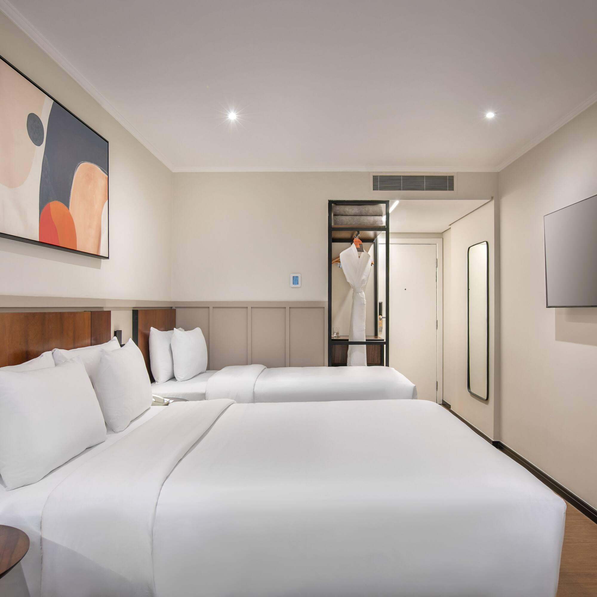 a room with two beds and a tv