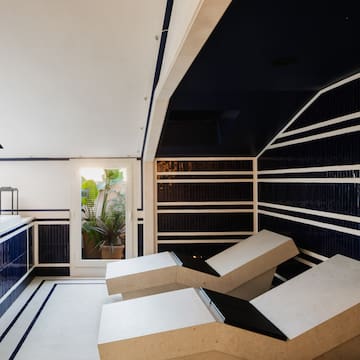 a room with white chairs and blue walls