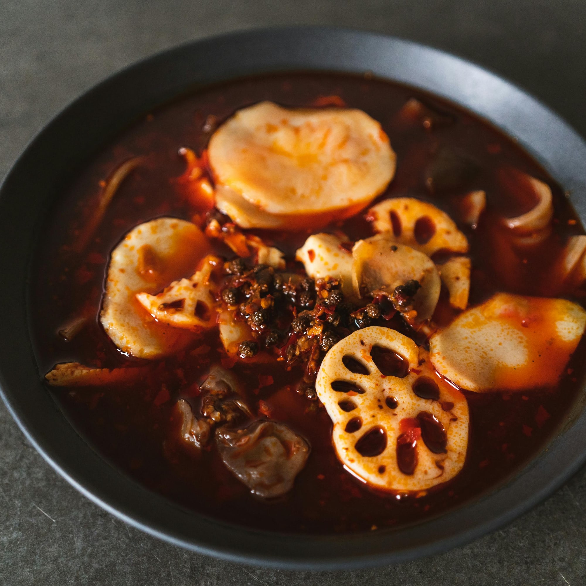 a bowl of soup with vegetables and meat