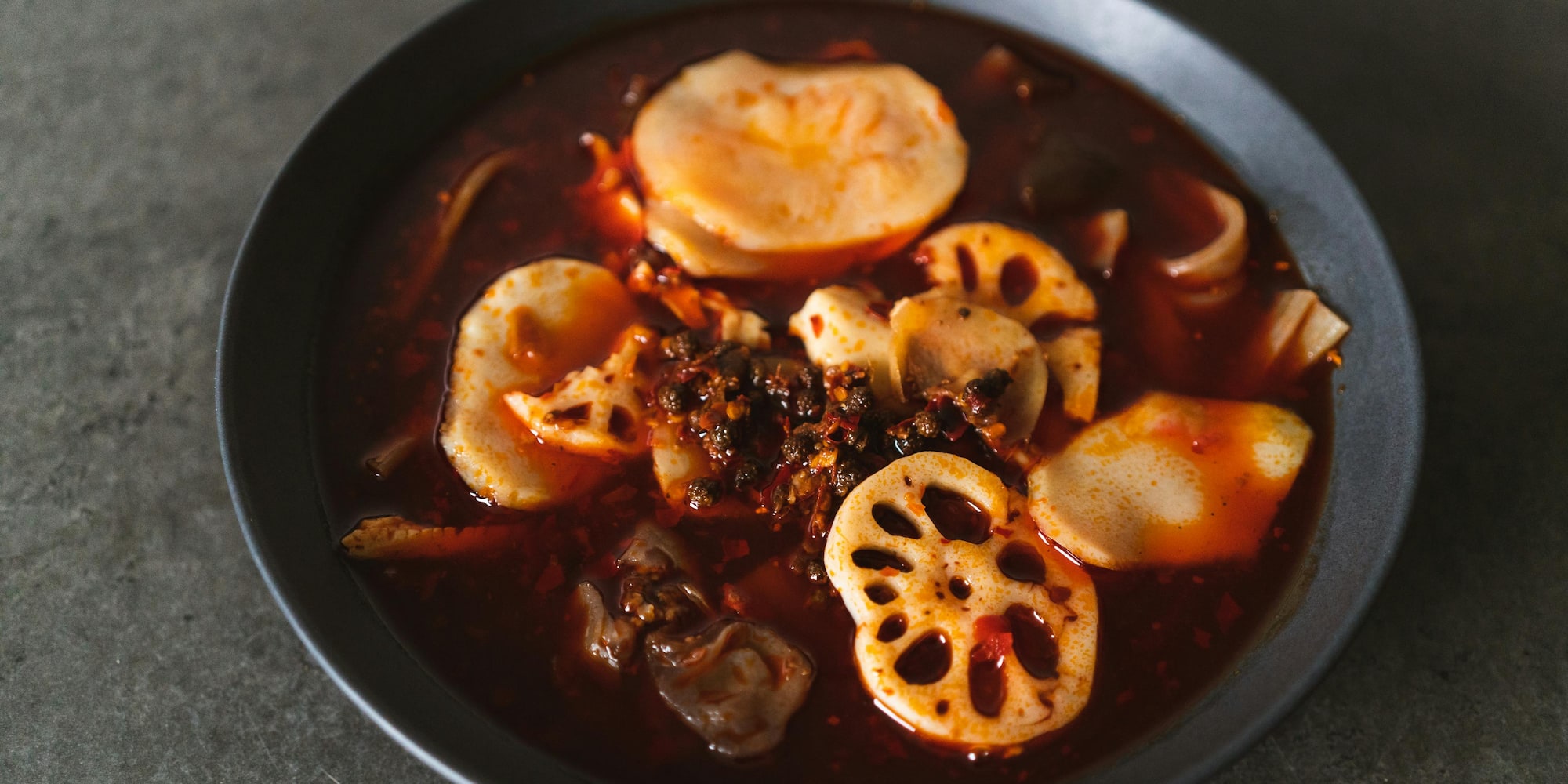 a bowl of soup with vegetables and meat