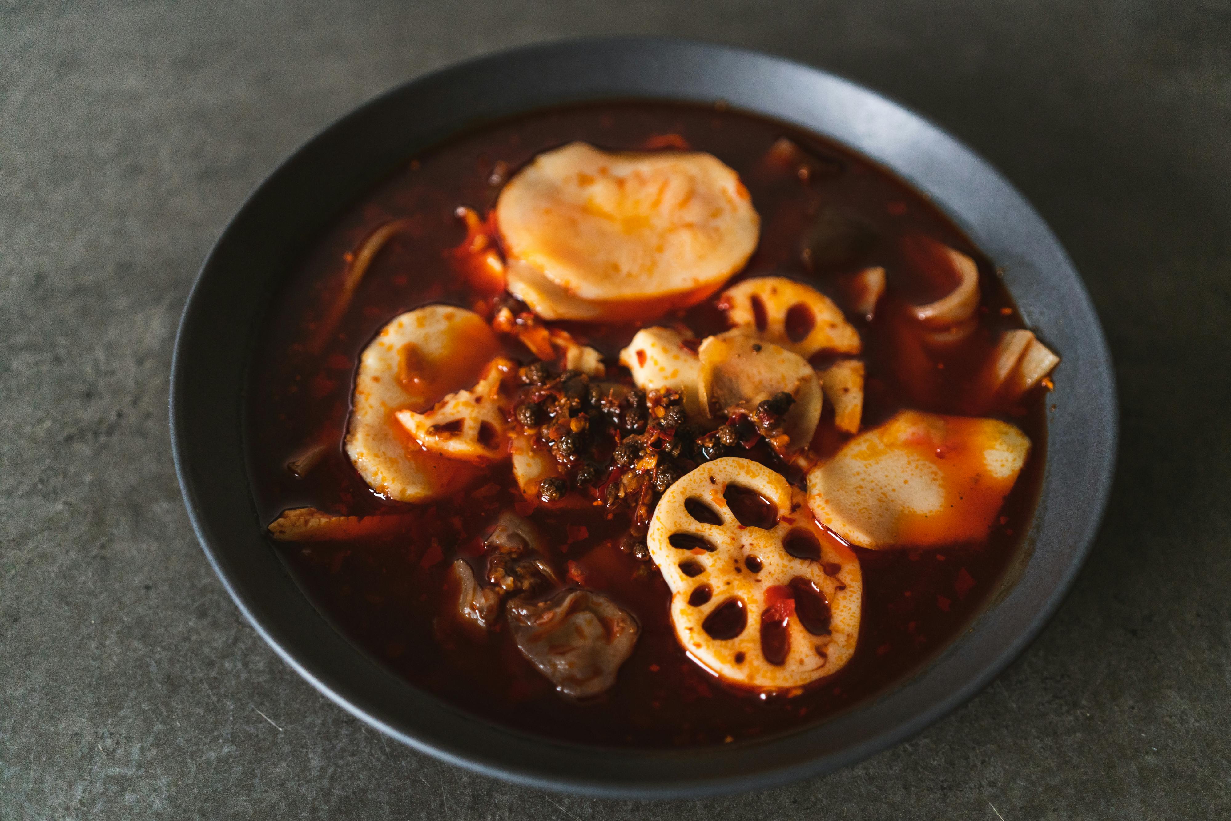 a bowl of soup with vegetables and meat