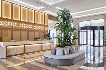 a lobby with a large plant in it