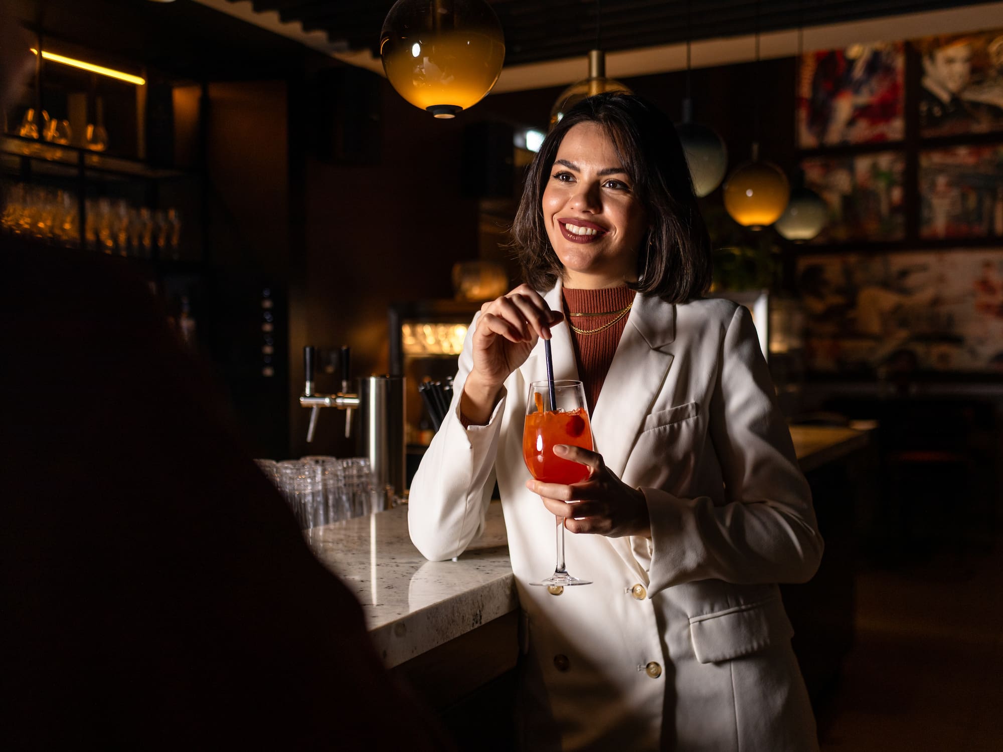 a woman holding a drink
