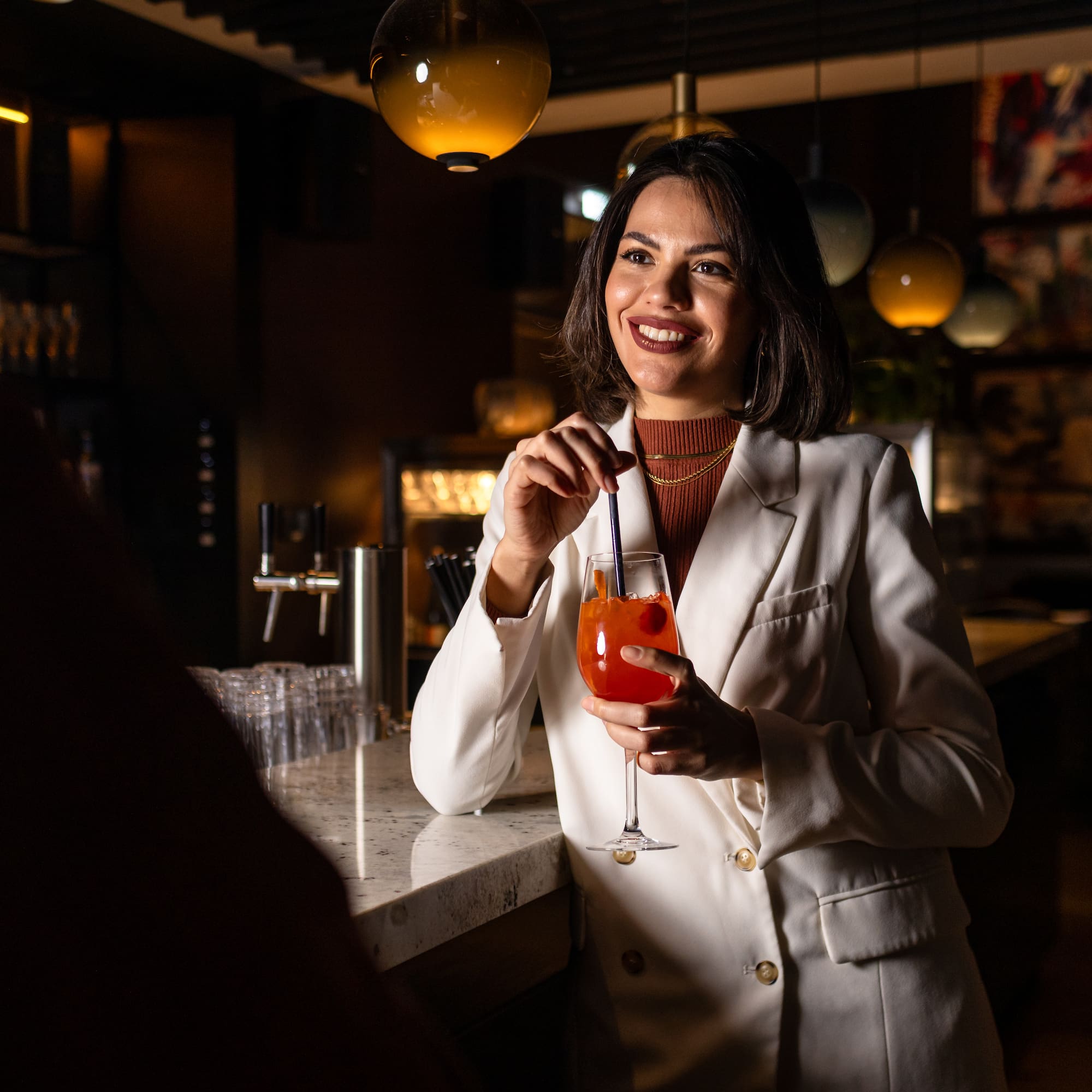 a woman holding a drink