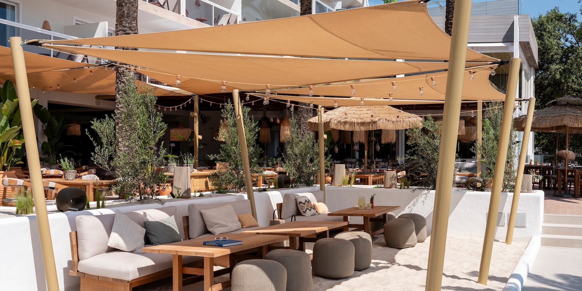 a patio area with a table and chairs and a canopy