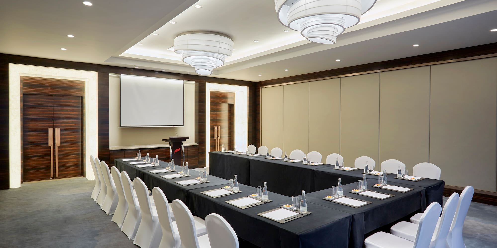 a room with a long table and chairs