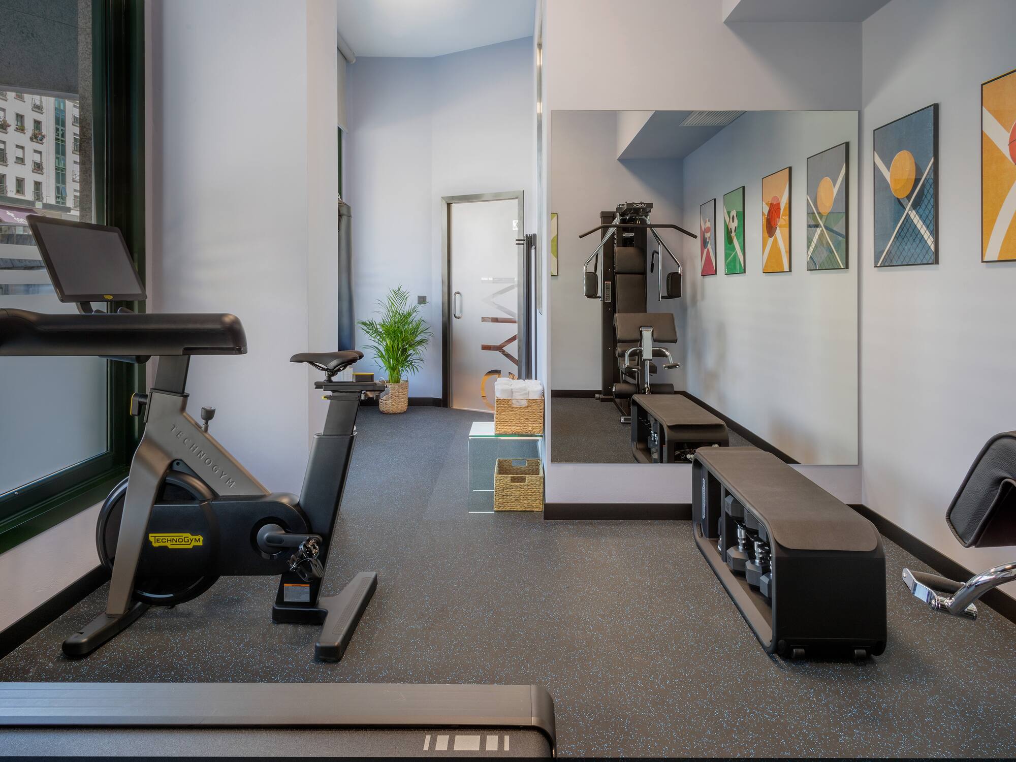a gym with exercise bikes and mirrors