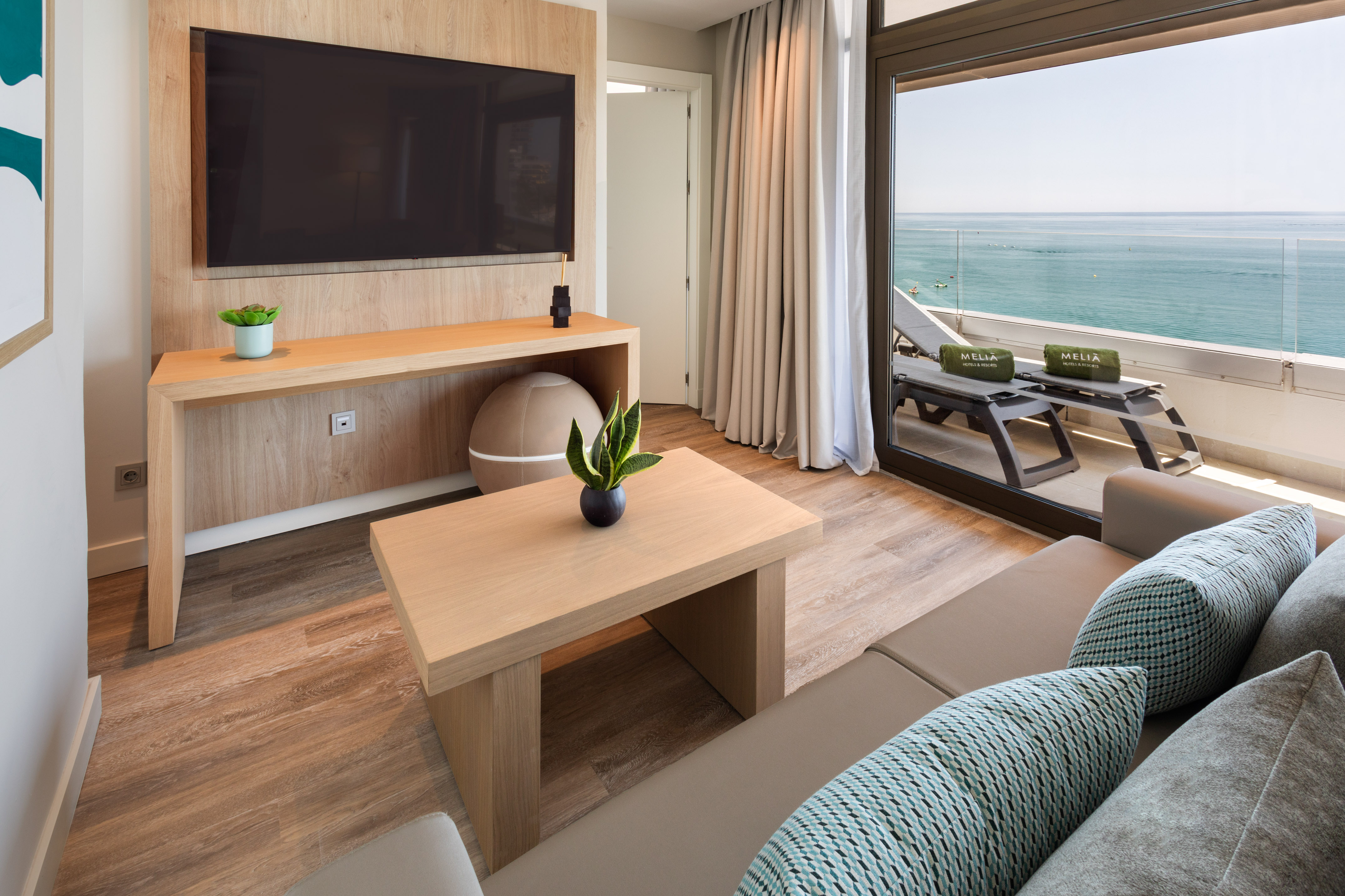 Elegant Meliá hotel suite living room with ocean view balcony