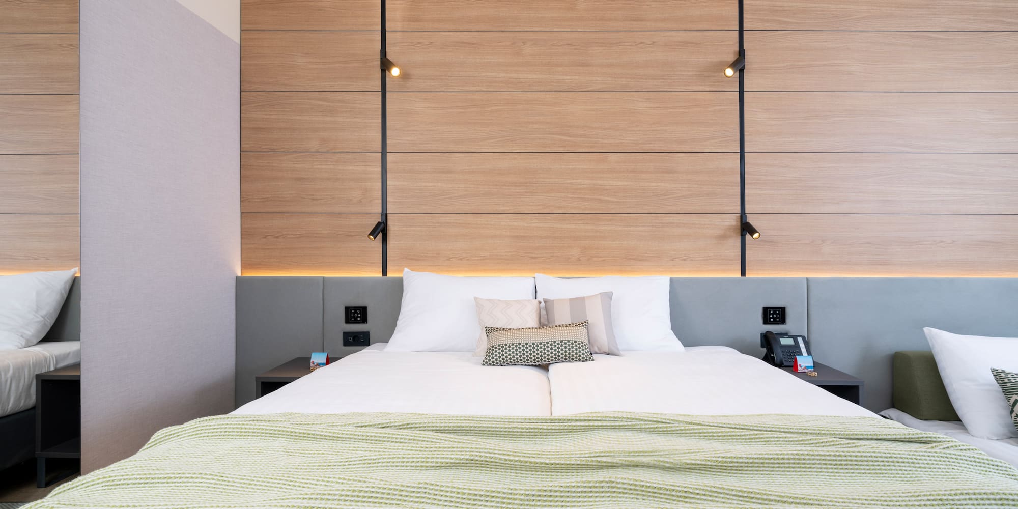 a bed with pillows and a wood paneled wall