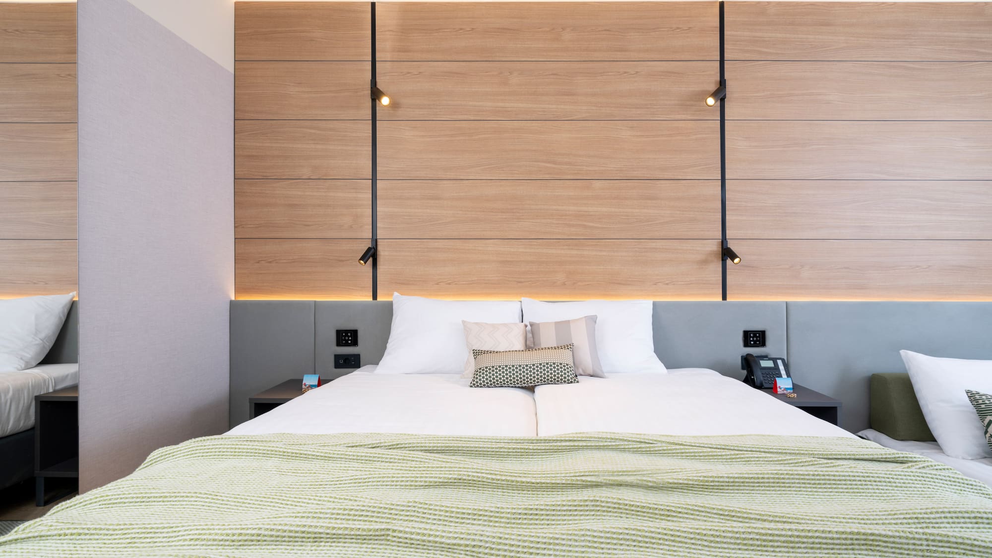 a bed with pillows and a wood paneled wall