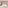 a bed with pillows and a wood paneled wall