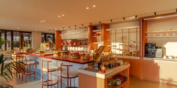 a kitchen with a counter and stools