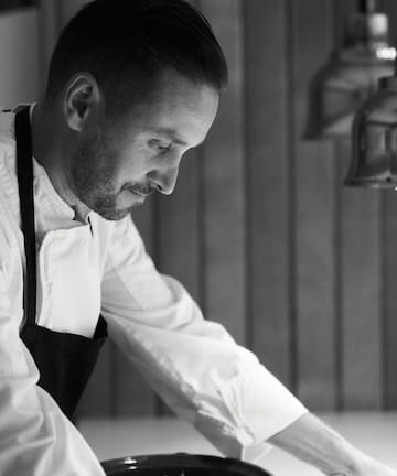 a man in a white shirt and apron