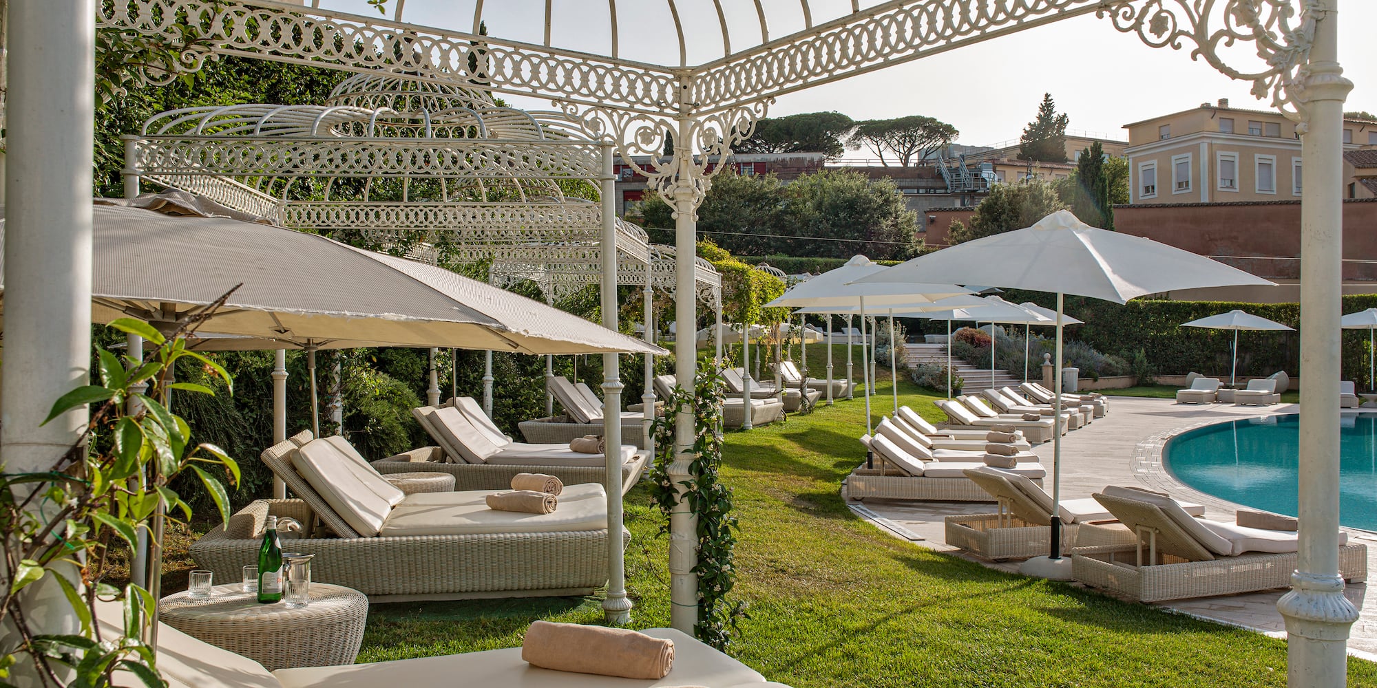 a pool with lounge chairs and umbrellas